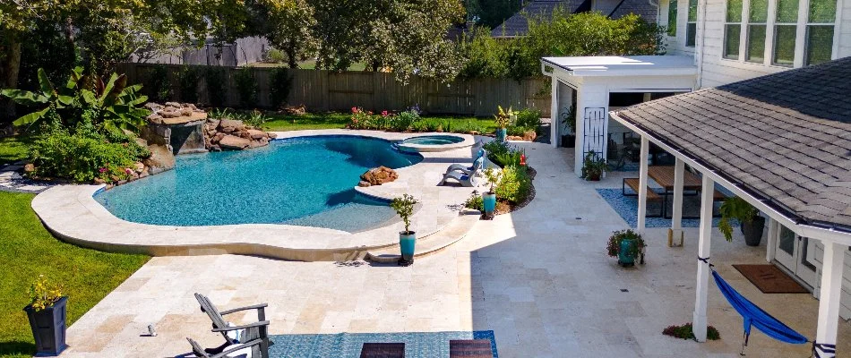 Backyard pool with landscaping in Crosby, TX.