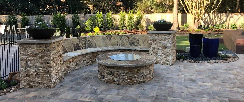 Fire pit with a matching seating wall on a patio in Kingwood, TX.