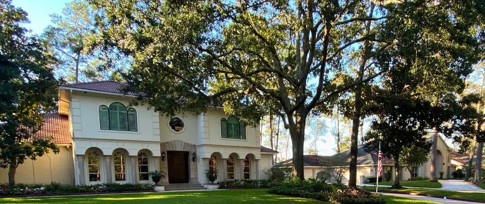 House in Kingwood, TX, with tall trees.