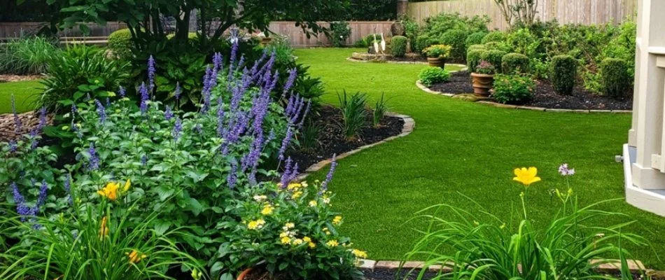 Landscape bed in Humble, TX, with colorful flowers.