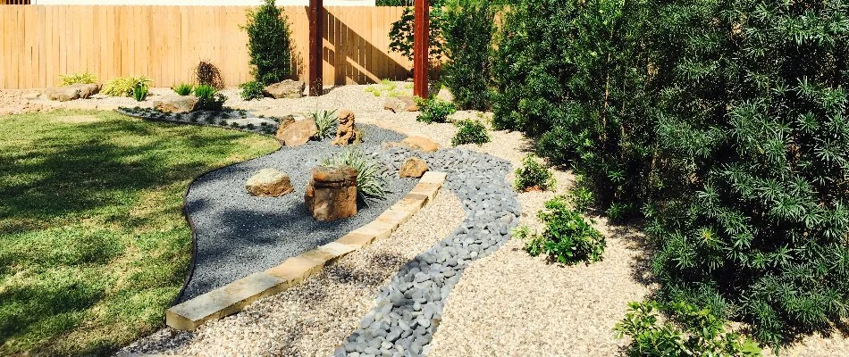 Landscape in Kingwood, TX, with rocks and shrubs.