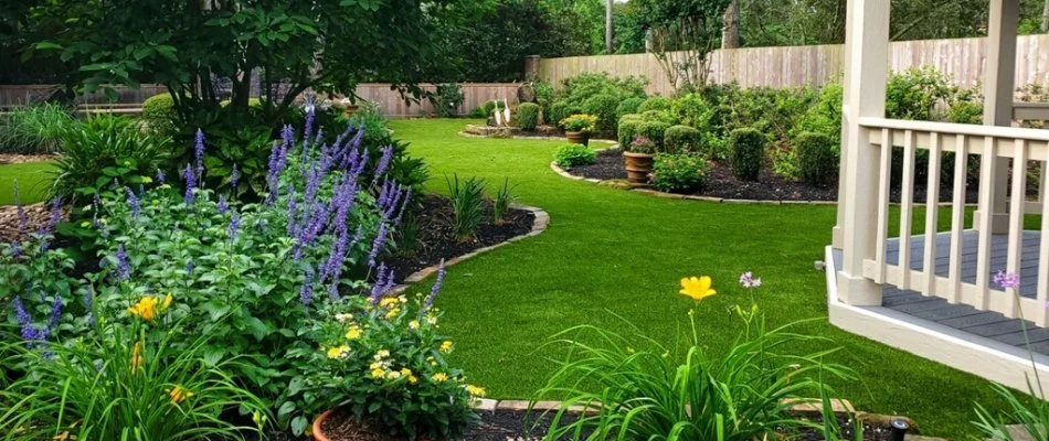 Lush plantings and grass in a yard in Kingwood, TX.