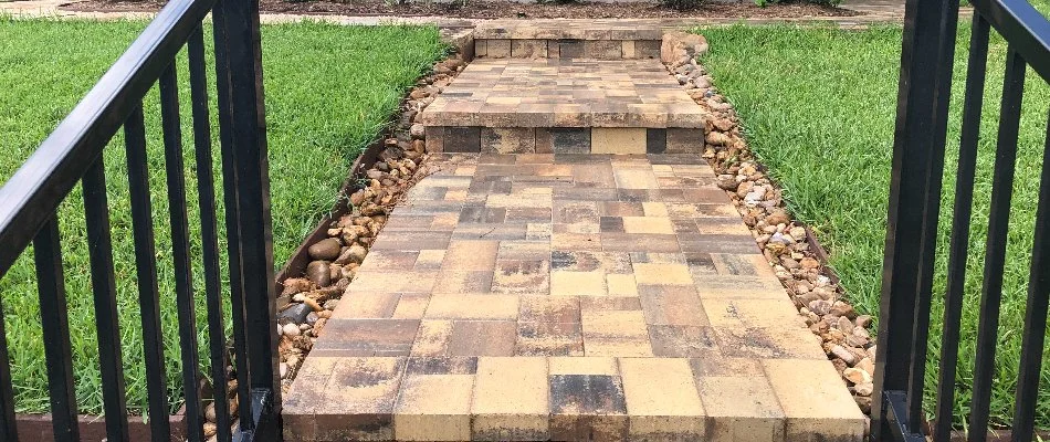 Paver outdoor steps lined with rocks in Kingwood, TX.