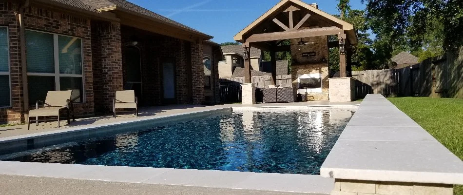 Swimming pool and a pavilion with a fireplace in Humble, TX.