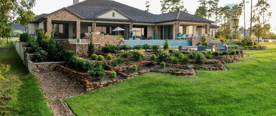 Tiered stone retaining walls with planter beds.