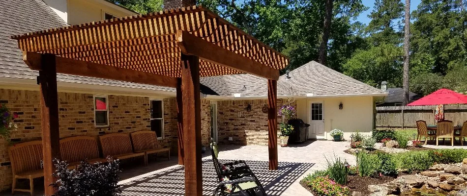 Wooden pergola over a patio in Kingwood, TX.